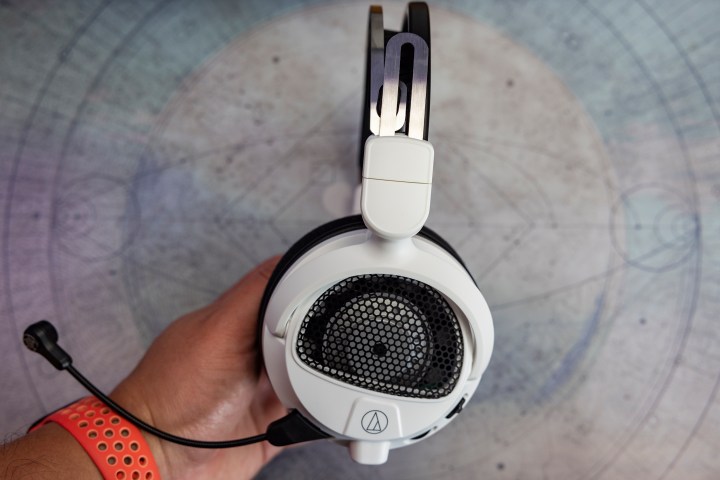 Audio-Technica ATH-GDL3 open-back gaming headphones being held by a hand.