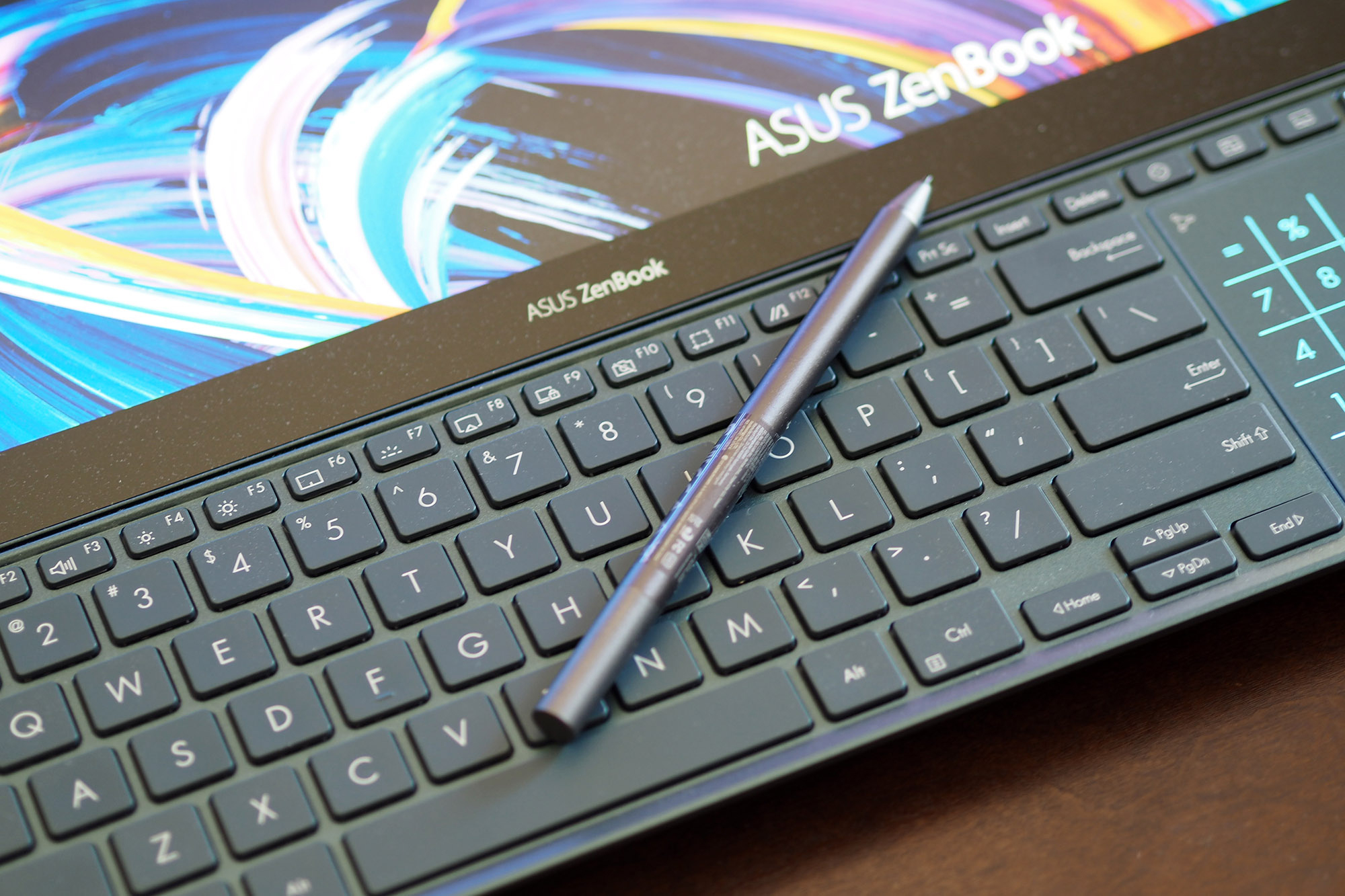 Asus ZenBook Pro Duo 15's keyboard with stylus sitting on top.