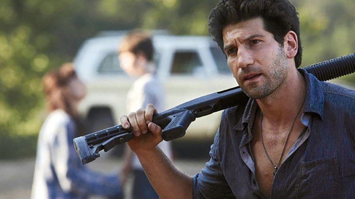 Shane holding a rifle in a scene from The Walking Dead.