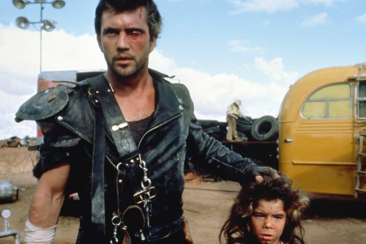 Mel Gibson holds the head of a young child in Mad Max 2.