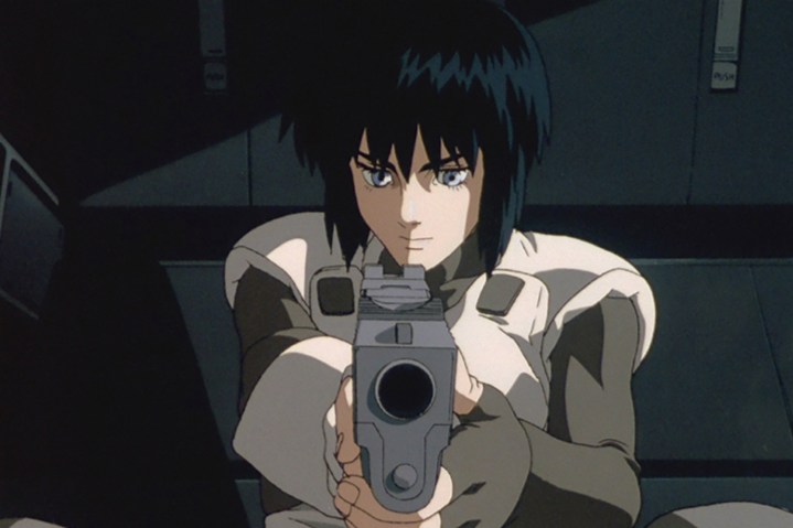 A character points a gun at the camera in Ghost in the Shell. 