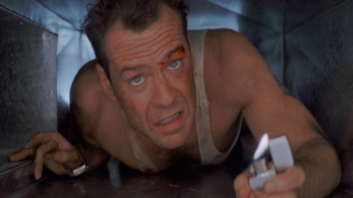 Bruce Willis holds a lighter in a scene from Die Hard.