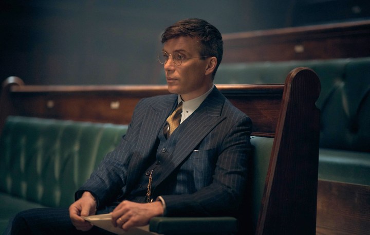 Cillian Murphy sitting with glasses. 