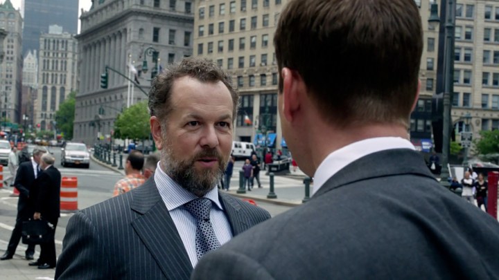 Daniel Hartman talking to someone outside in a scene from Suits.