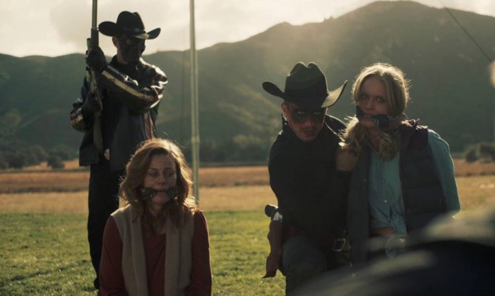 A group of cowboys hold two women hostage in The Forever Purge.