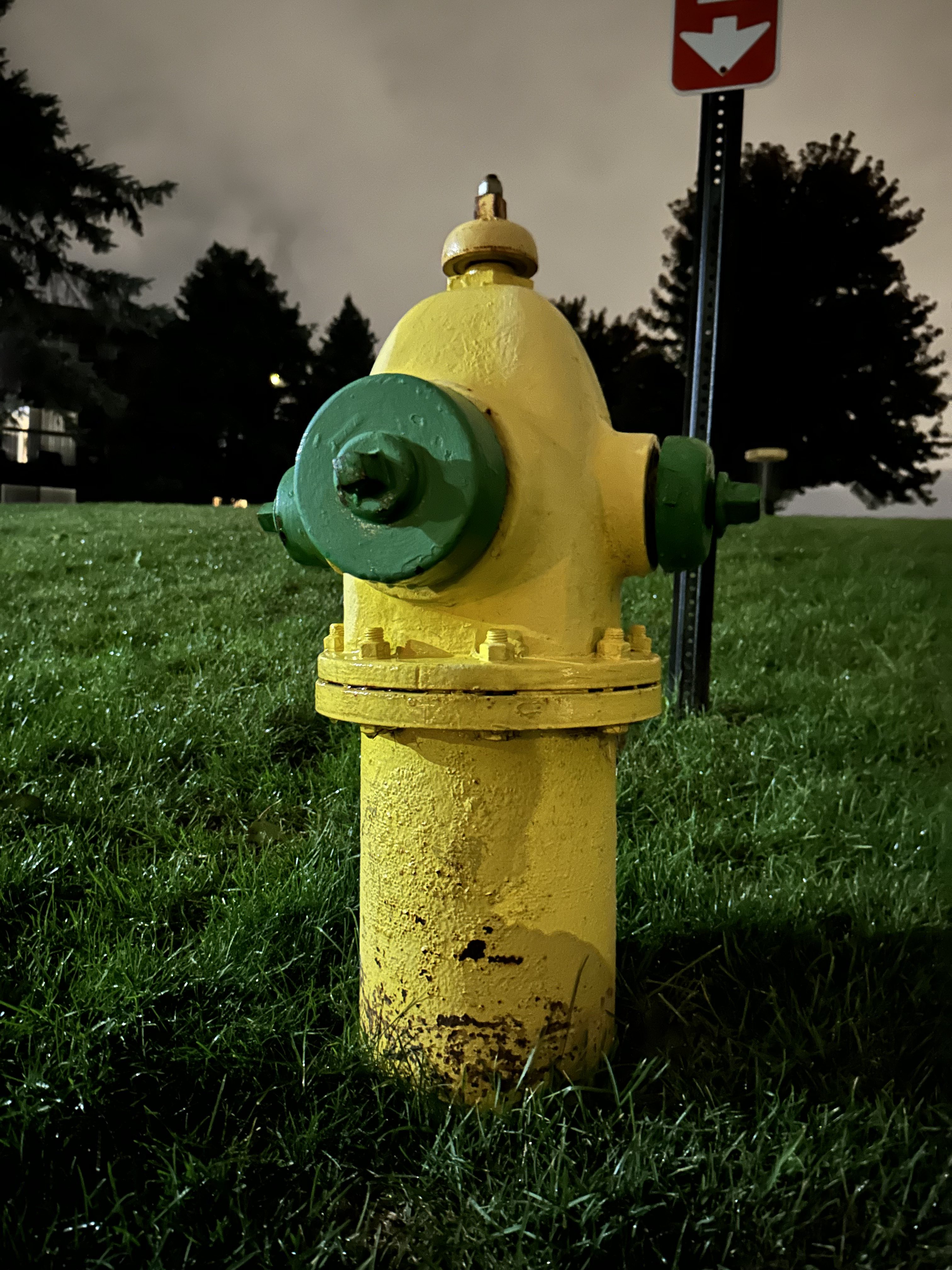 Photo of a yellow fire hydrant at night, taken with the iPhone 14 Pro Max.