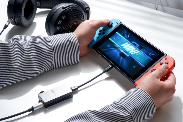 Astell&Kern HB1 Bluetooth DAC/amp seen with portable game console.