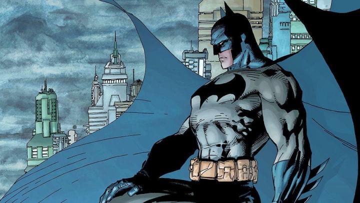 Batman looks over Gotham City in a comic book rendering.