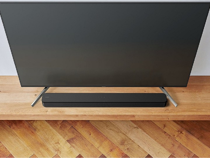 The Sony S100F soundbar at the foot of a TV.
