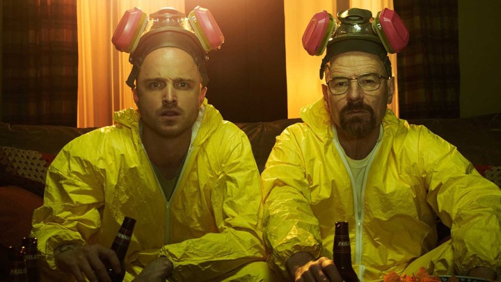 Jesse and Walt from Breaking Bad in hazmat suits drinking beers.
